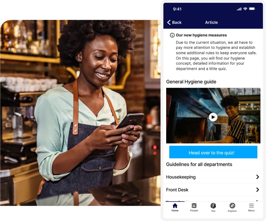Smiling barista in an apron checks her phone; next to her is a mobile app screen showing hygiene measures and a quiz button.