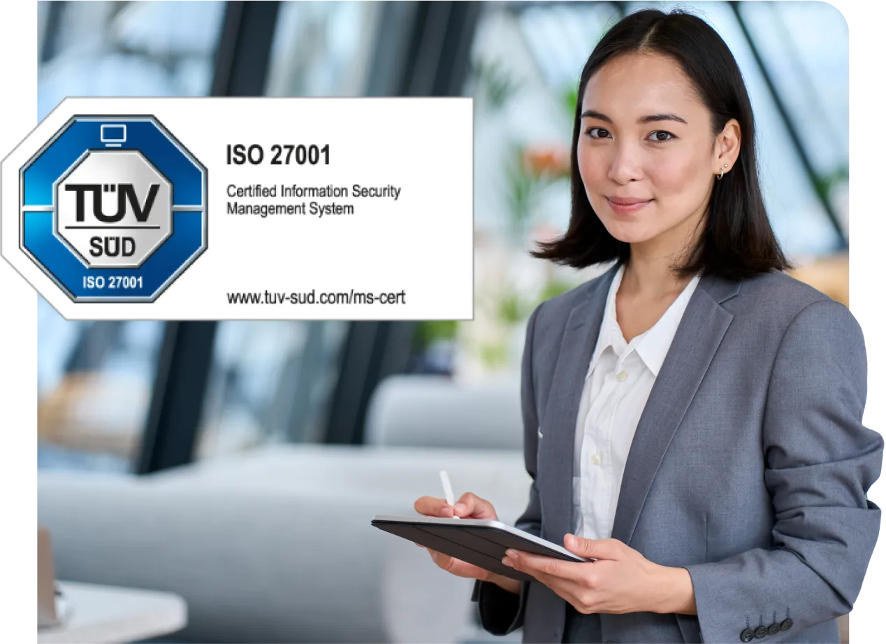 Businesswoman in a gray suit holding a tablet, standing next to an ISO 27001 certification sign for information security management.