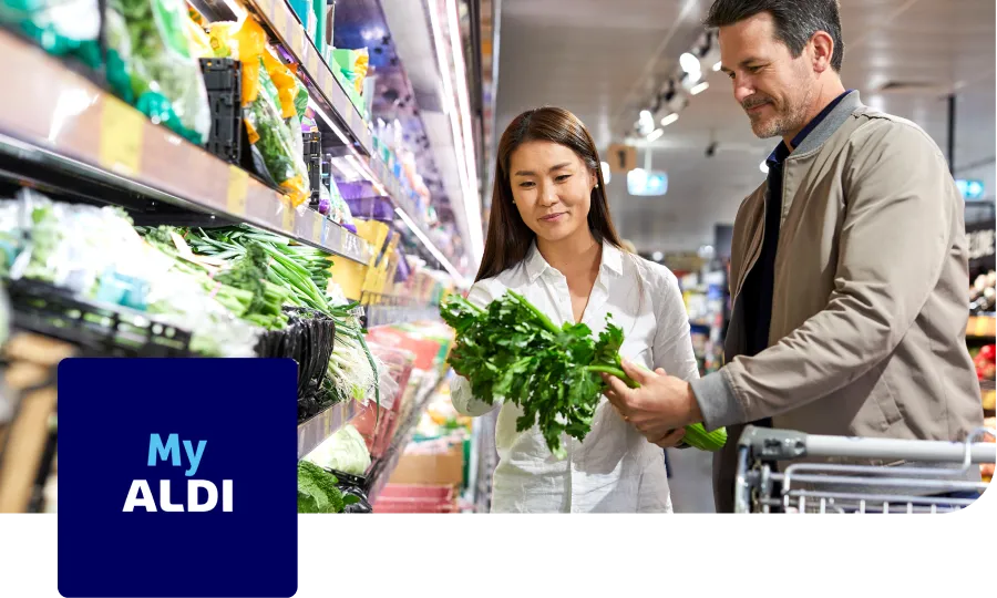 Men and women standing next to a fridge in Aldi