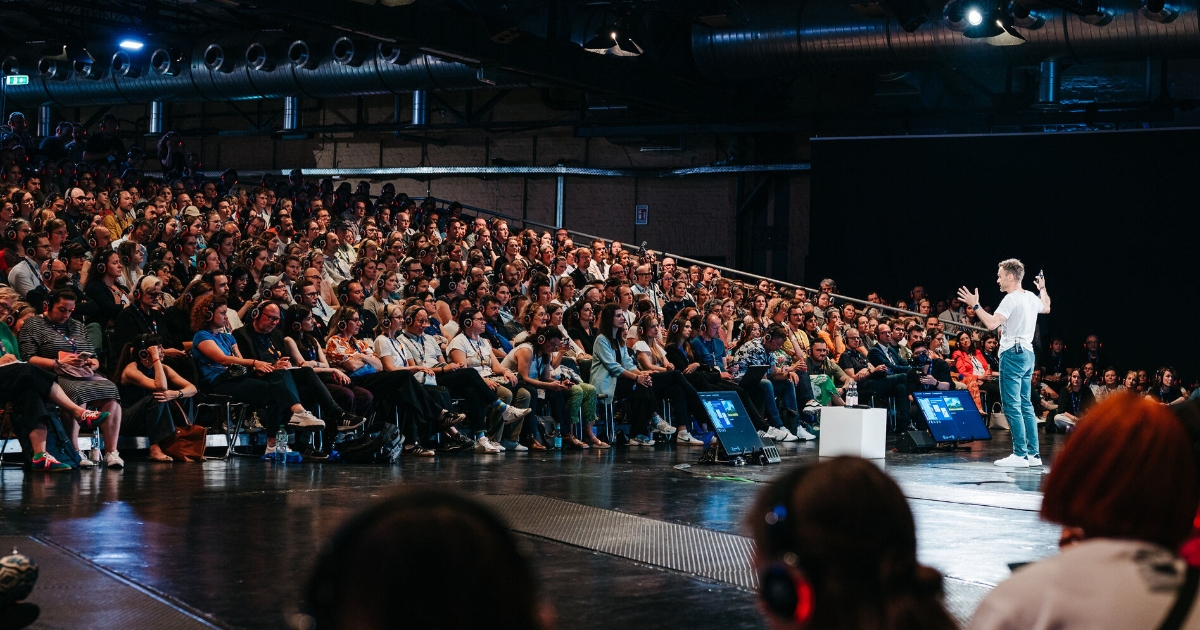 Frank Wolf speaking about AI at VOICES 2025 in front of big audience