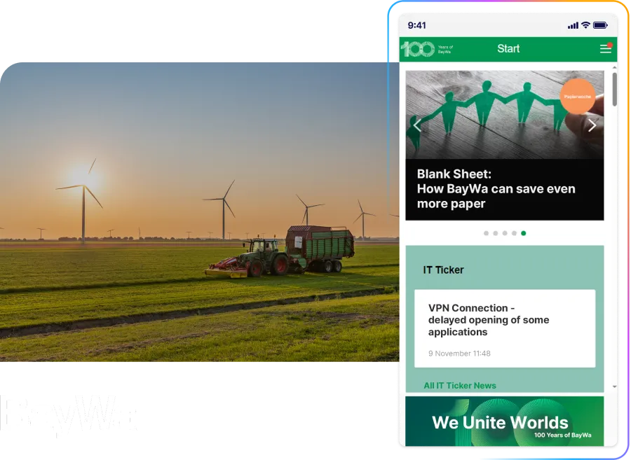 A tractor in a wind turbine field at sunset, with a smartphone displaying BayWa's website featuring sustainability content.
