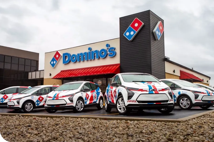 Cars in front of the Domino's pizza place