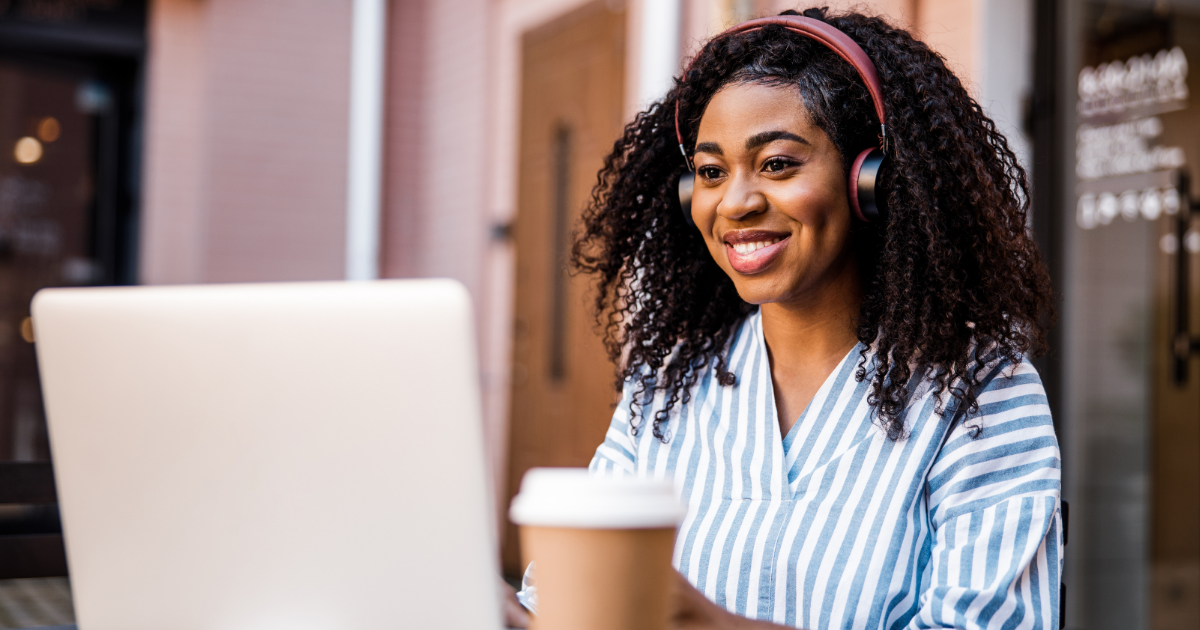 worker smiling over a laptop