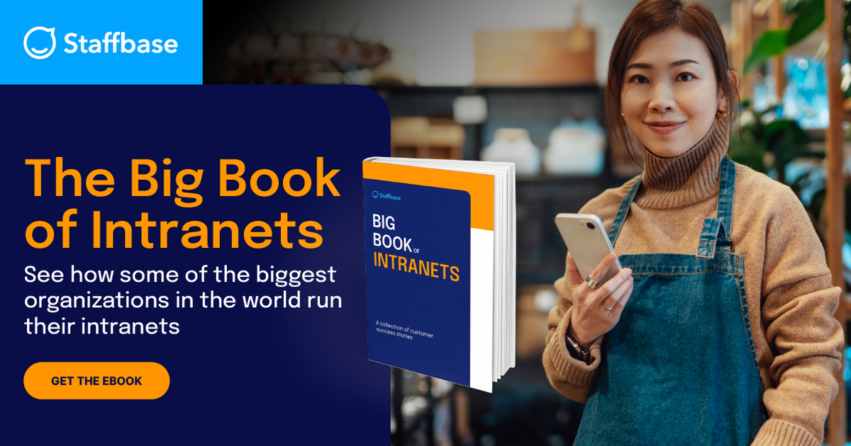 "Promotional graphic from Staffbase featuring a young woman in a beige turtleneck and denim apron holding a smartphone, smiling at the camera. On the left side, bold text reads: 'The Big Book of Intranets – See how some of the biggest organizations in the world run their intranets.' A 3D rendering of the book 'Big Book of Intranets' is displayed next to the text, along with an orange button labeled 'Get the Ebook.'