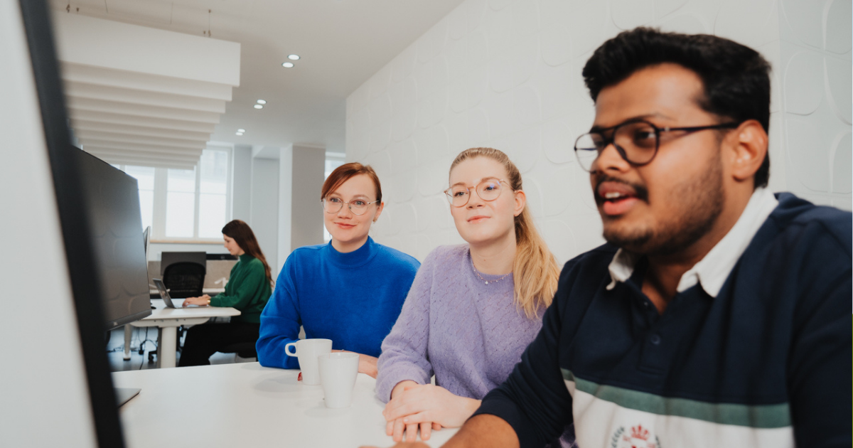 several coworkers looking at a screen at work