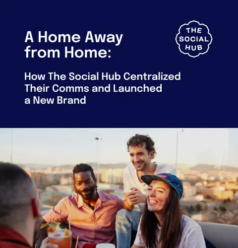 Group of people smiling and talking on a rooftop with drinks, under a text about The Social Hub's brand launch.