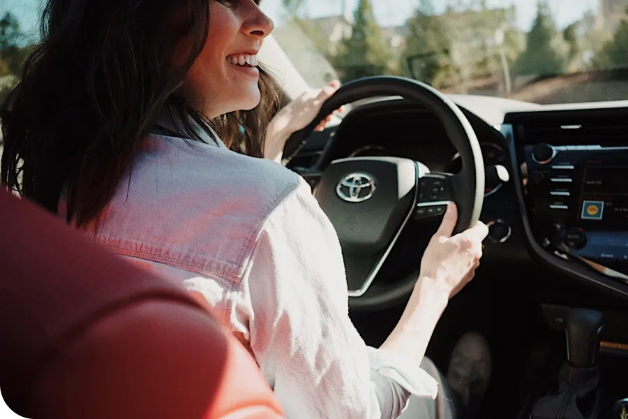 A women driving a Toyota vehicle