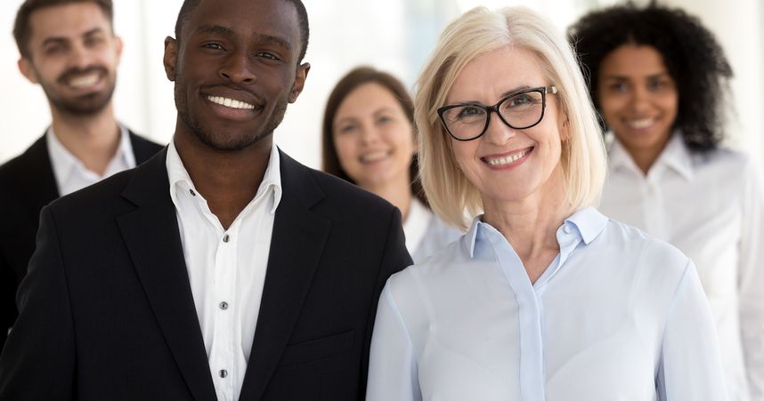 A photograph of a diverse old and young group of employees