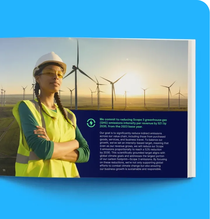 A woman in safety gear stands in a wind farm, with a text overlay about reducing greenhouse gas emissions by 2030.