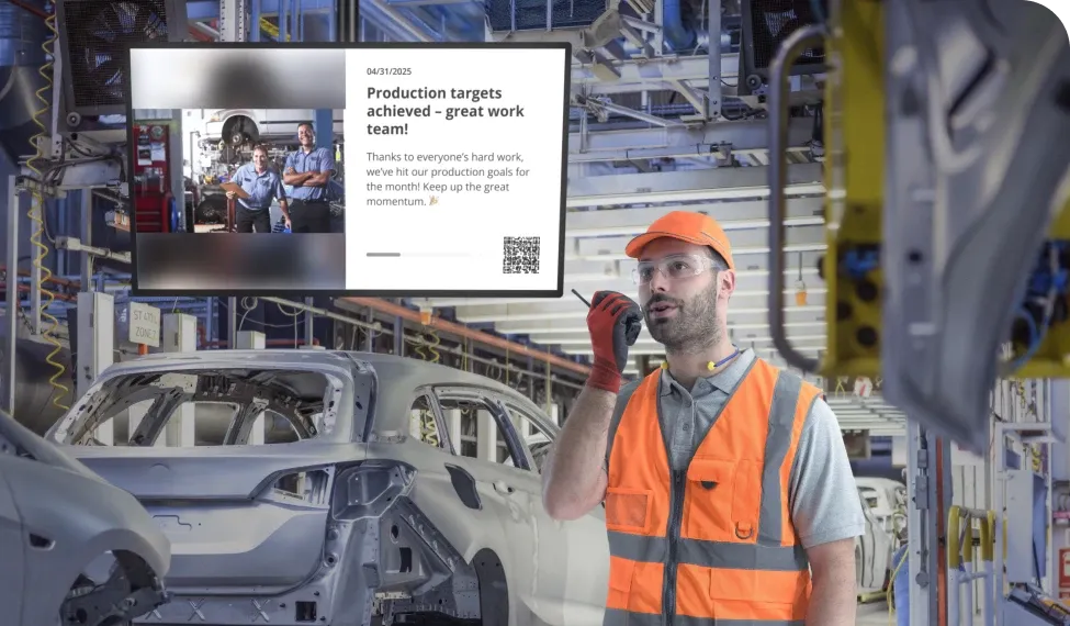 A factory worker in an orange vest and helmet communicates via radio. A screen displays a message about achieving production targets.