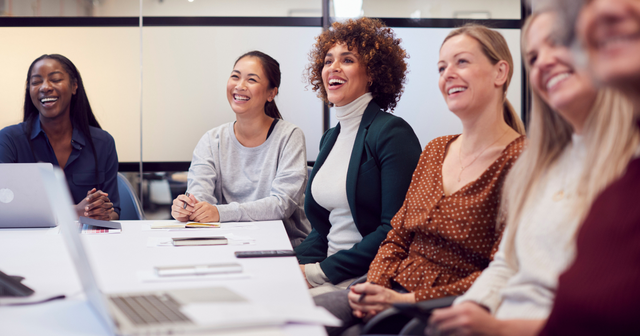 Employee retention image featuring several people smiling in an office setting
