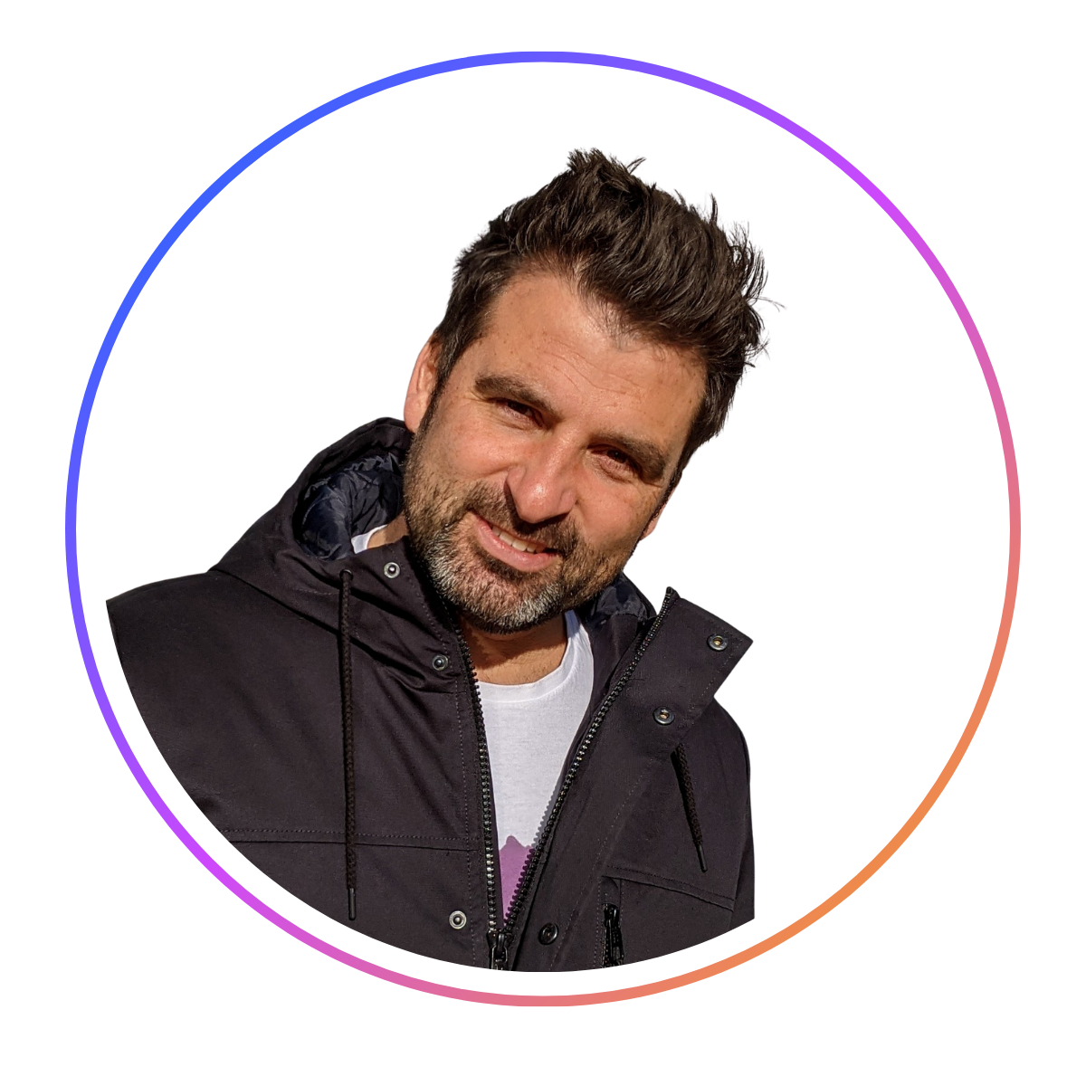 Man with dark hair and beard, wearing a black jacket, smiling at the camera. Circular frame with a gradient border.