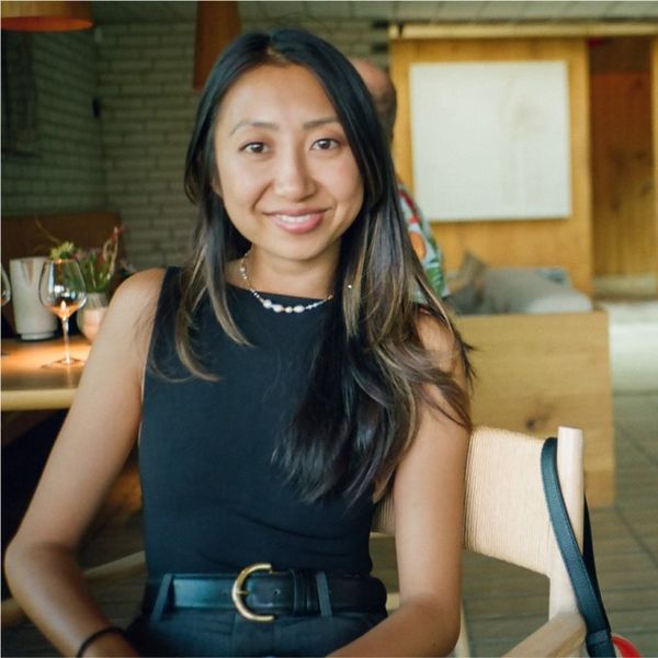woman in a black dress smiling