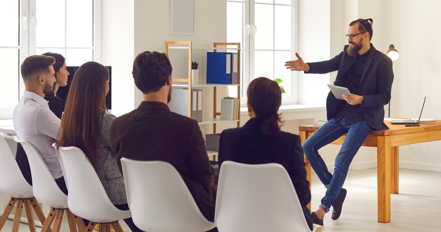 person speaks to a room of colleagues