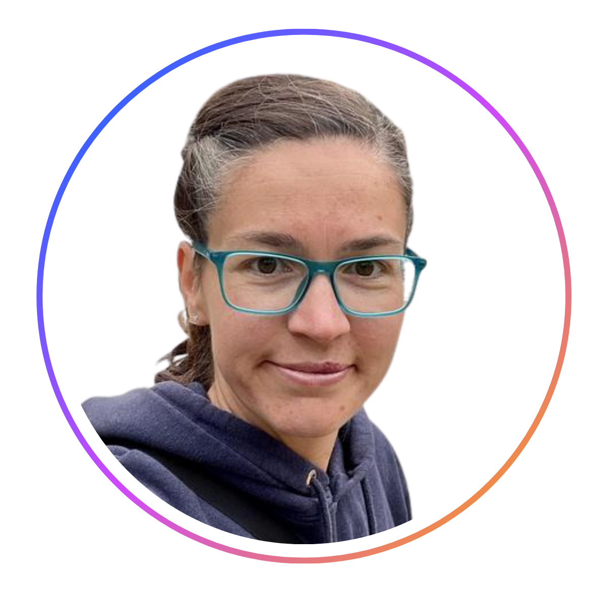 Person with glasses and dark hair tied back, wearing a navy hoodie, inside a circular frame with a gradient border, on a white background.