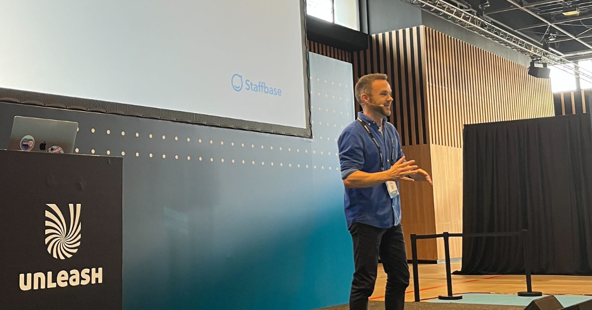 Frank Wolf of Staffbase speaks on stage at Unleash 2025.