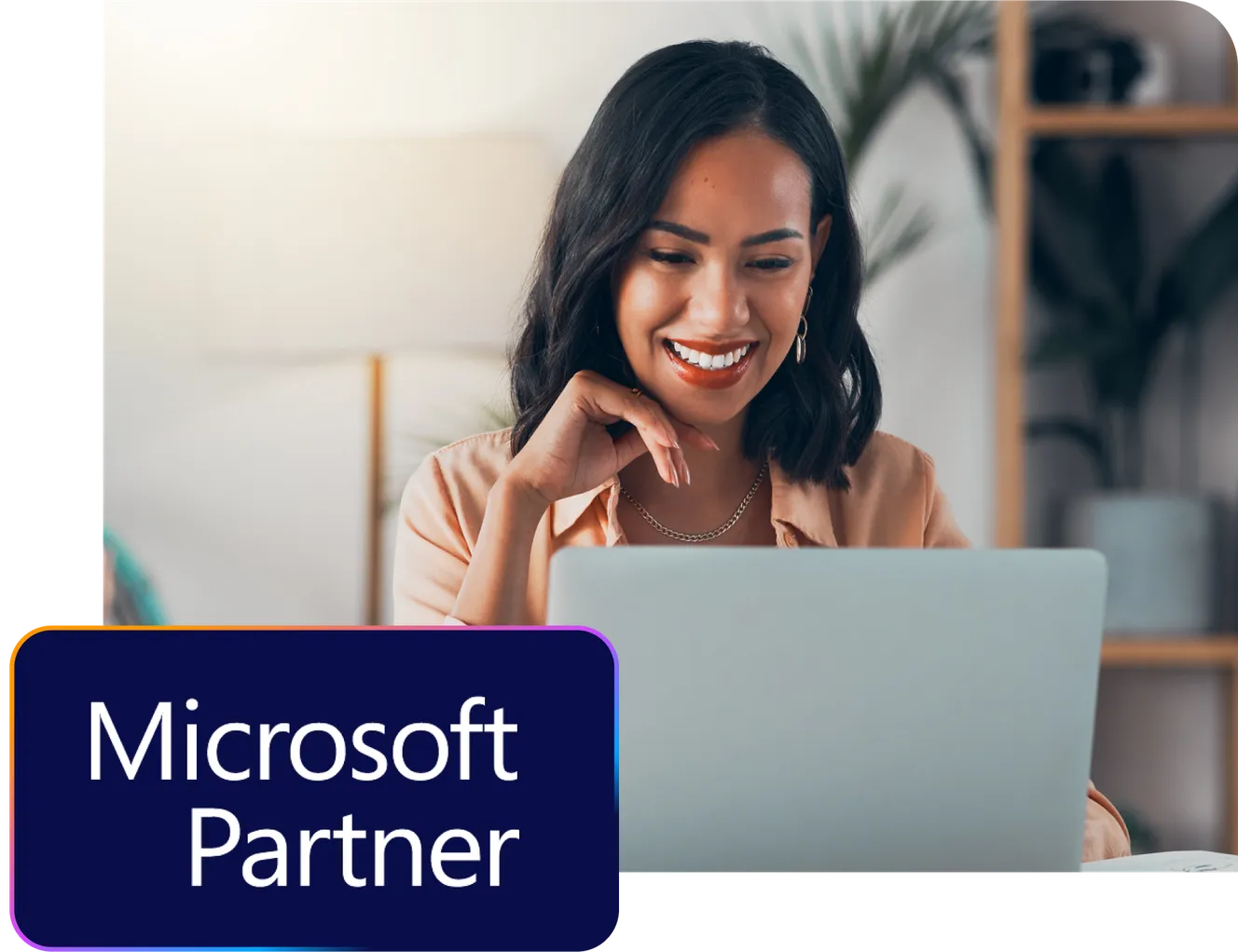 Smiling woman using a laptop, with a "Microsoft Partner" logo in the corner.