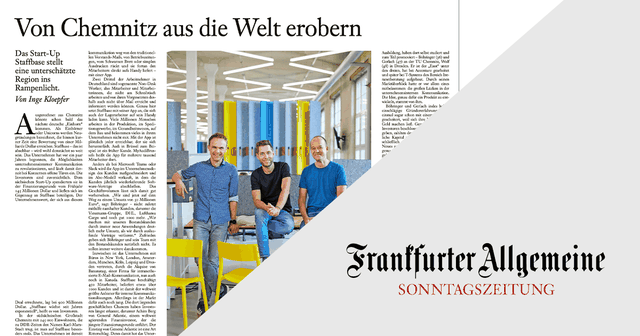 Three people sit on chairs in a modern office space with colorful columns, featured in a newspaper article from Frankfurter Allgemeine Sonntagszeitung.