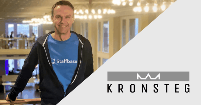 A person in a blue "Staffbase" shirt and dark jacket stands indoors, smiling. The logo "Kronsteg" is displayed on the right.