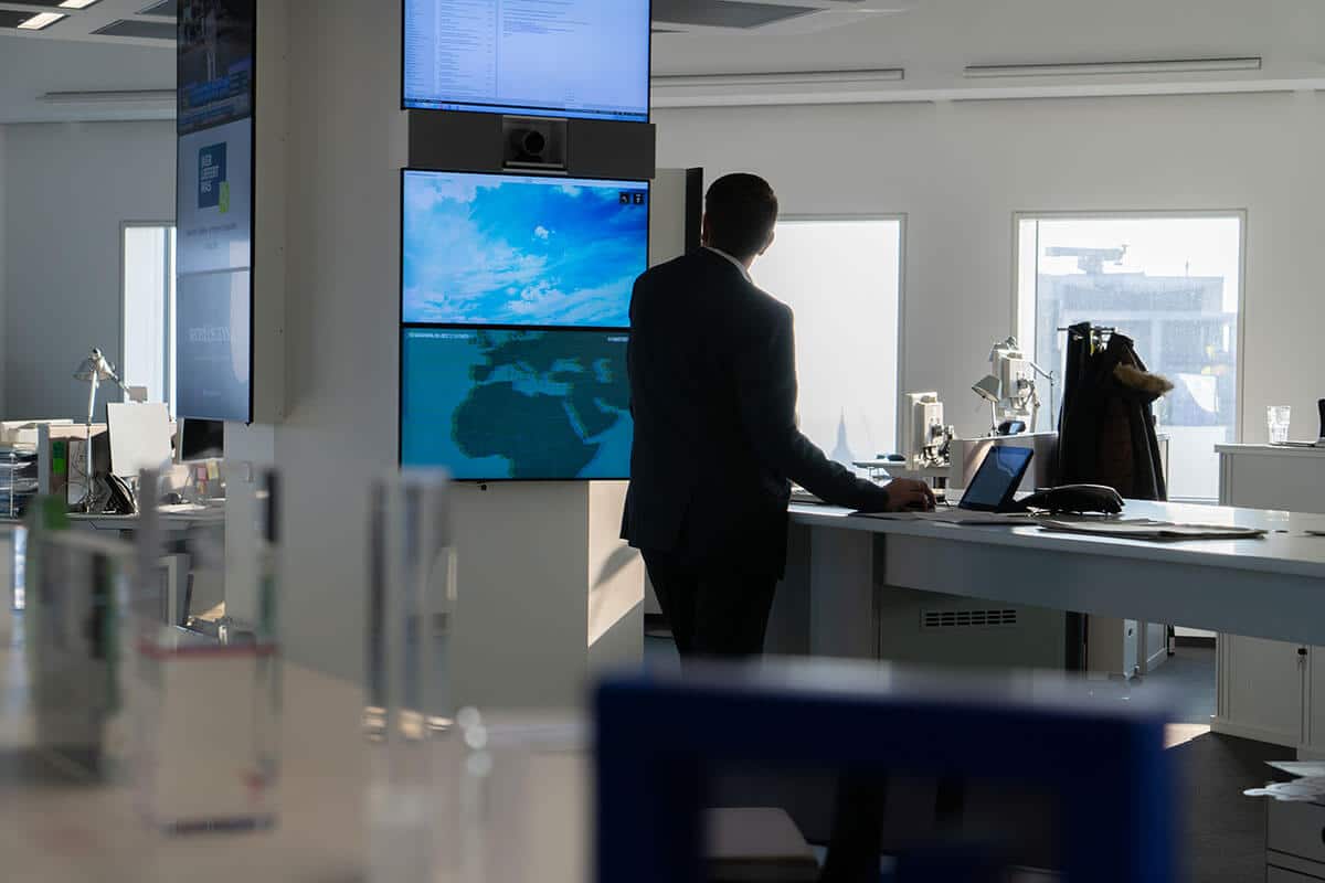 Ralf Drescher betrachtet Screens im Newsroom der Deutschen Bank