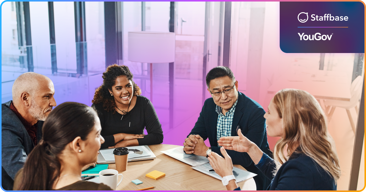 image of five coworkers at a table seemingly working and talking