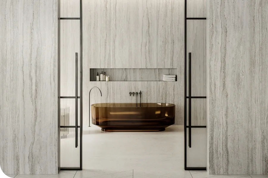 Minimalist bathroom with a sleek, brown freestanding bathtub, light stone walls, and a recessed shelf with toiletries and towels.