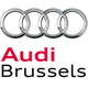 Audi logo with four interlocking silver rings above the text "Vorsprung durch Technik" in red and black.