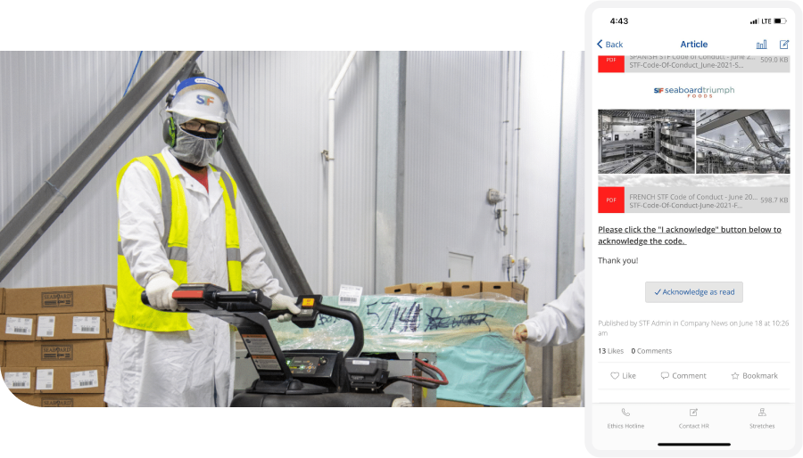 Worker in safety gear operates machinery in a warehouse. A mobile screen displays a company article acknowledgment prompt.