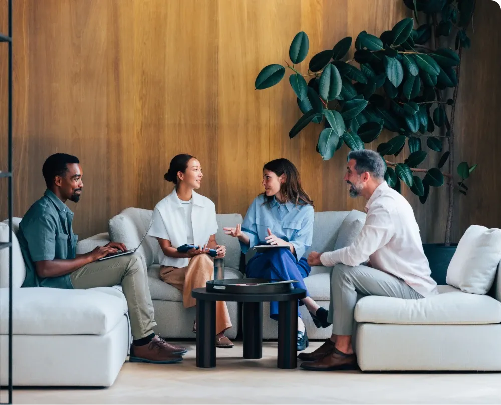 A group of diverse people sitting around a table discussing a new project