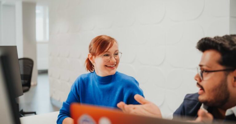 woman smiles off distance at coworker