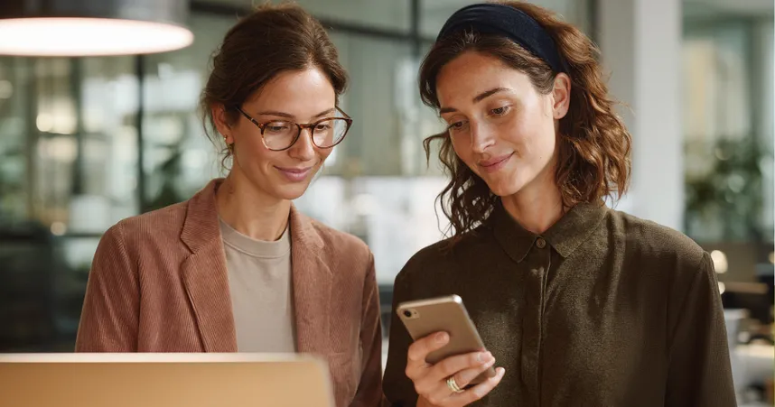 coworkers looking at phone