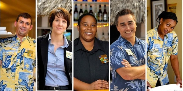 Five people in a collage, three wearing yellow floral shirts and two in dark shirts, smiling in a hospitality setting.