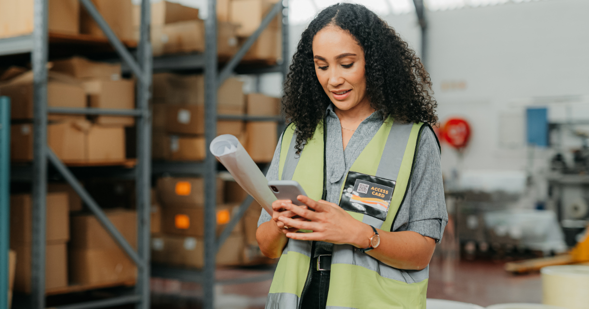 image of woman on phone at work wearing a safety vest