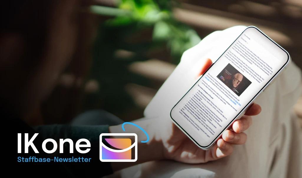 Person holding a smartphone displaying a newsletter.