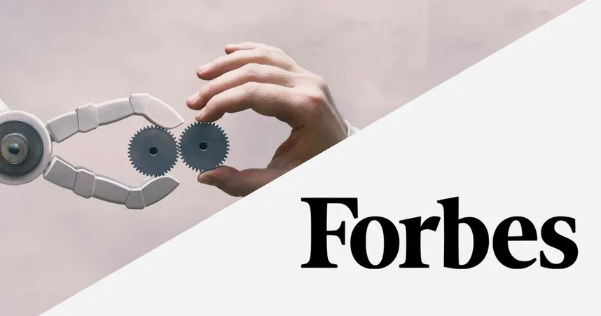 A human hand and a robotic claw hold gears, symbolizing synergy. Forbes logo in the foreground.