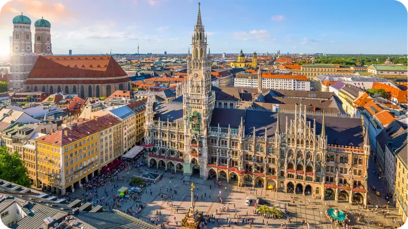 Aerial view of Munich's Marienplatz with the New Town Hall tower and Frauenkirche in the background.