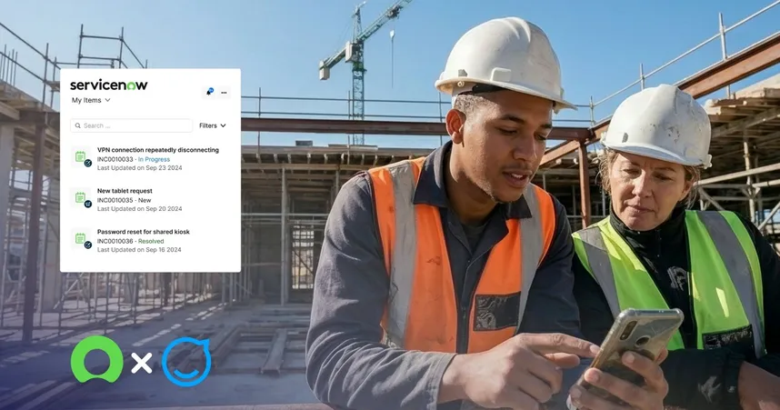 two workers in safety gear and hard hats looking at a mobile device while on site