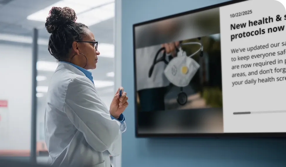 A doctor in a lab coat reads a digital screen displaying new health and safety protocols, with a stethoscope and mask image.