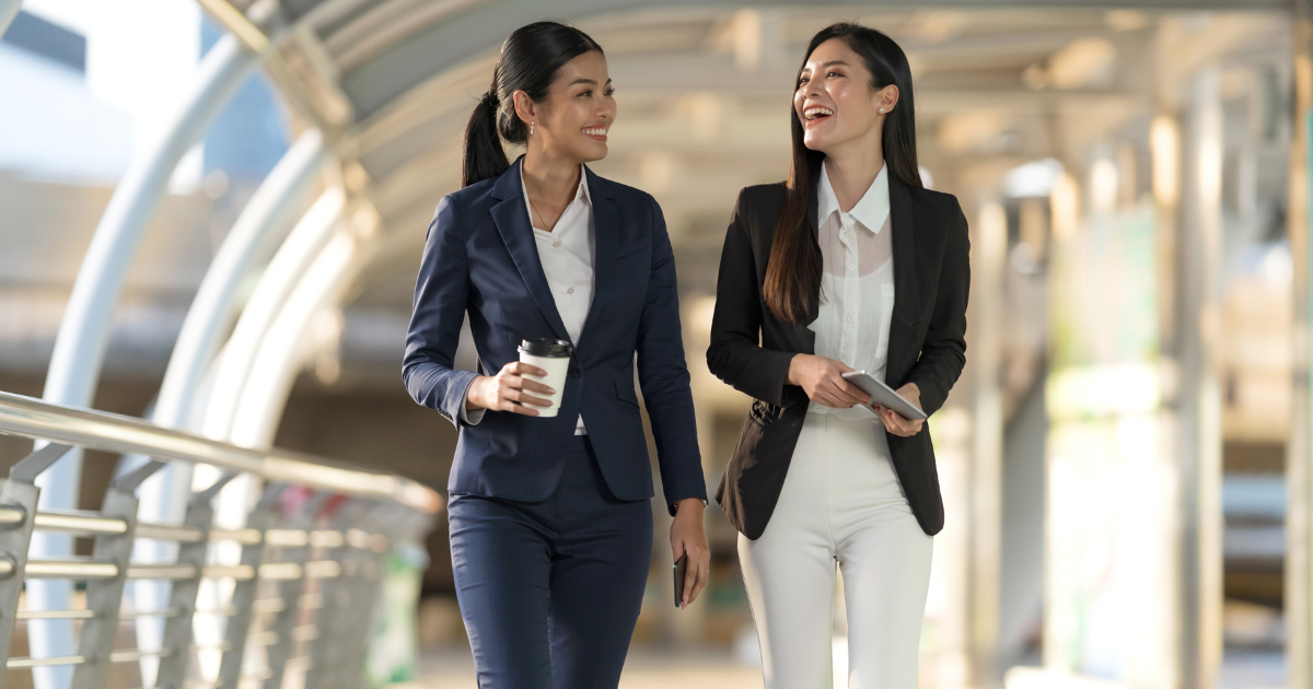 women talking and walking at work