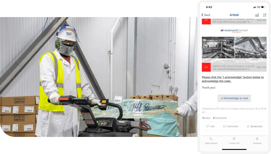 Worker in safety gear operates machinery in a warehouse. A mobile screen displays a company article acknowledgment prompt.