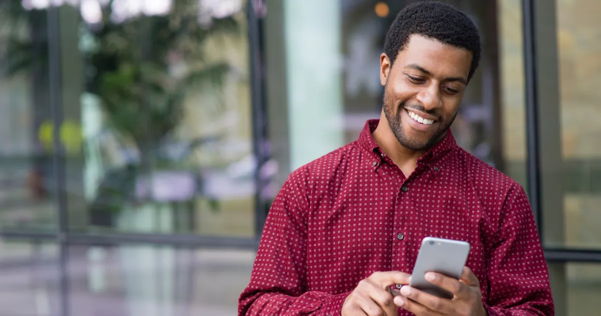 man smiling at phone