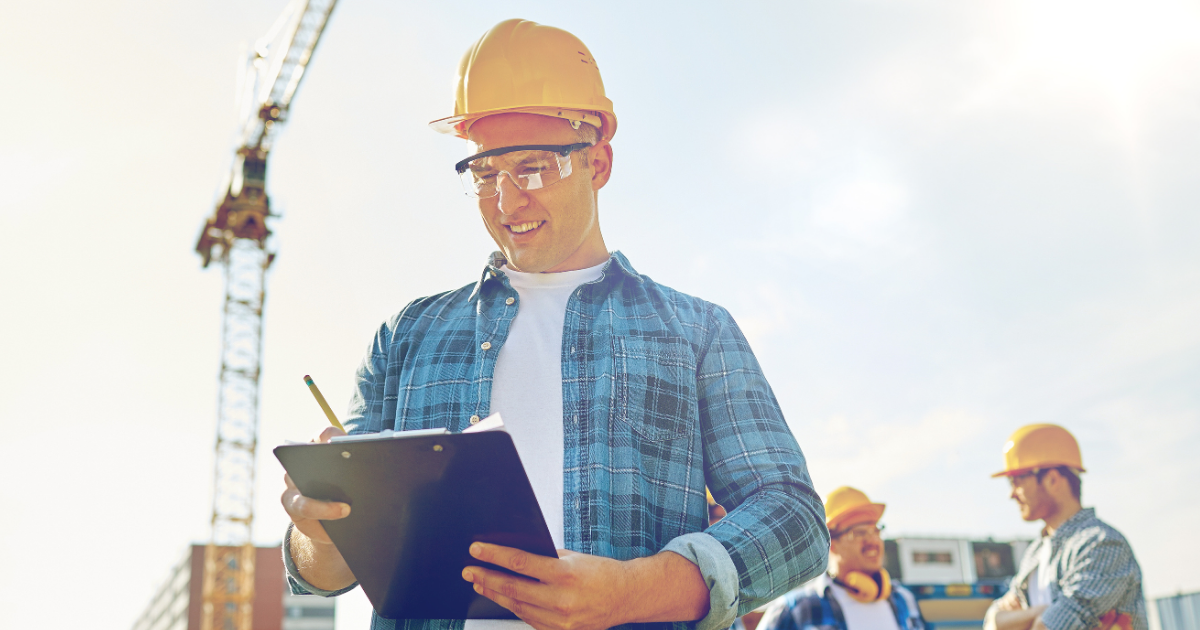workers in hardhats with a checklist