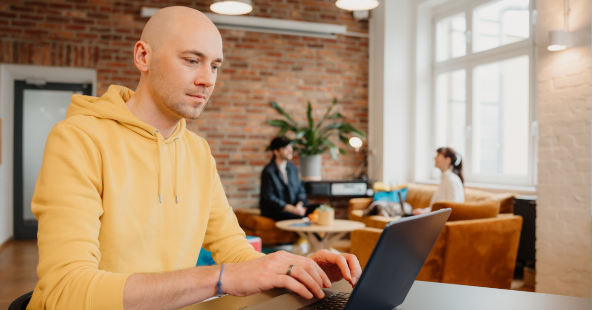 man working on laptop in office setting