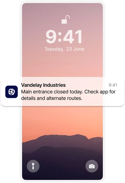 Smartphone lock screen showing a notification from Vandelay Industries about a closed entrance, with a pink-hued mountain landscape background.