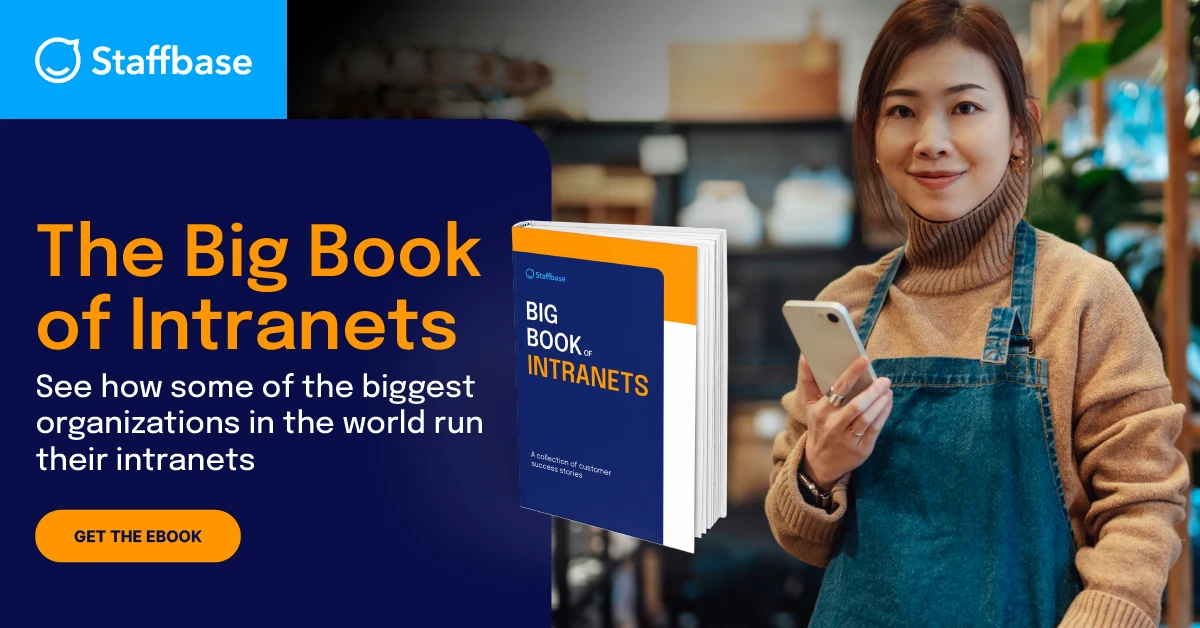 "Promotional graphic from Staffbase featuring a young woman in a beige turtleneck and denim apron holding a smartphone, smiling at the camera. On the left side, bold text reads: 'The Big Book of Intranets – See how some of the biggest organizations in the world run their intranets.' A 3D rendering of the book 'Big Book of Intranets' is displayed next to the text, along with an orange button labeled 'Get the Ebook.'