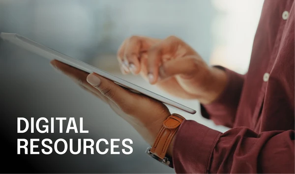 Person using a tablet with "Digital Resources" text overlay, wearing a maroon shirt and brown watch. Blurred background.