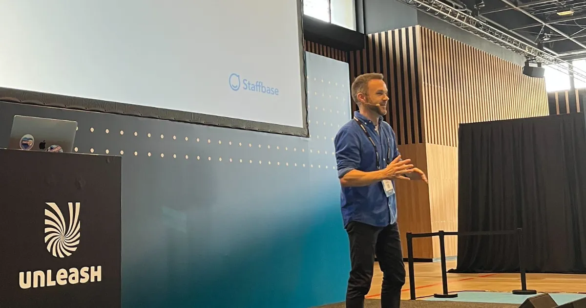 Frank Wolf of Staffbase speaks on stage at Unleash 2025.
