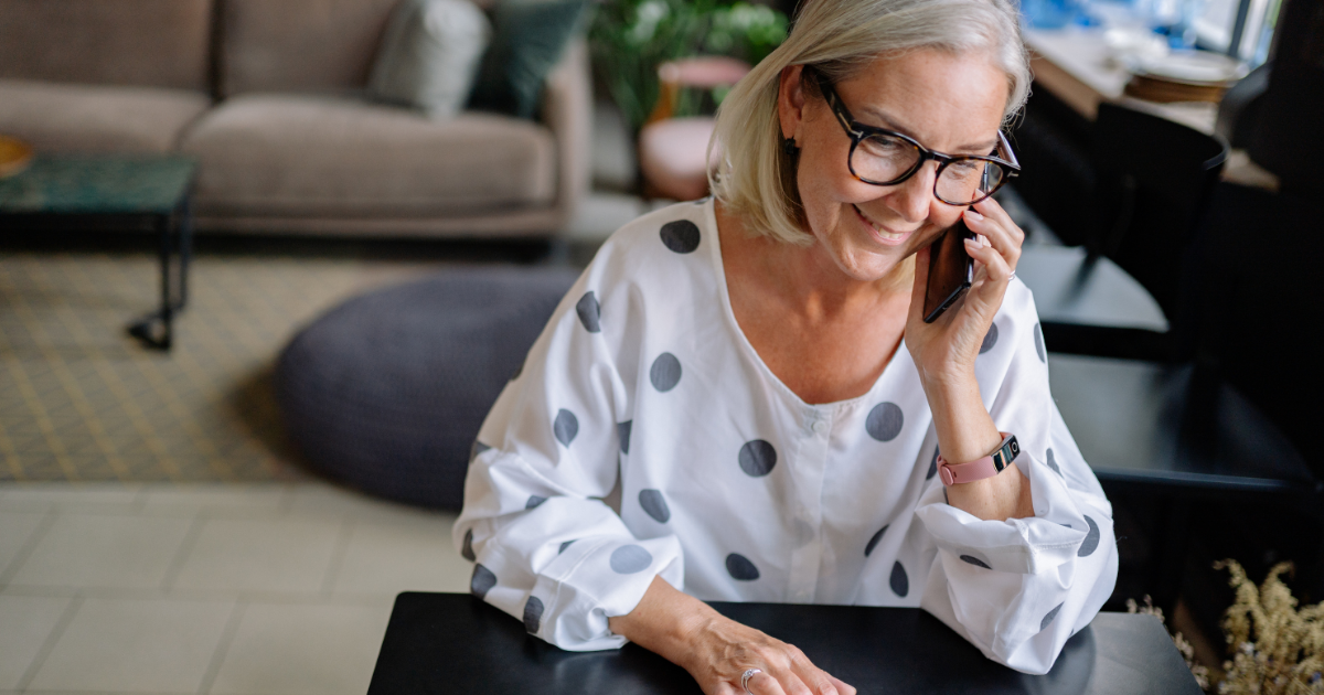 woman on phone smiling off camera