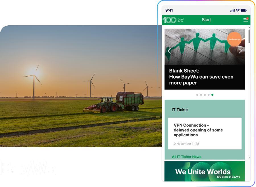 A tractor in a wind turbine field at sunset, with a smartphone displaying BayWa's website featuring sustainability content.
