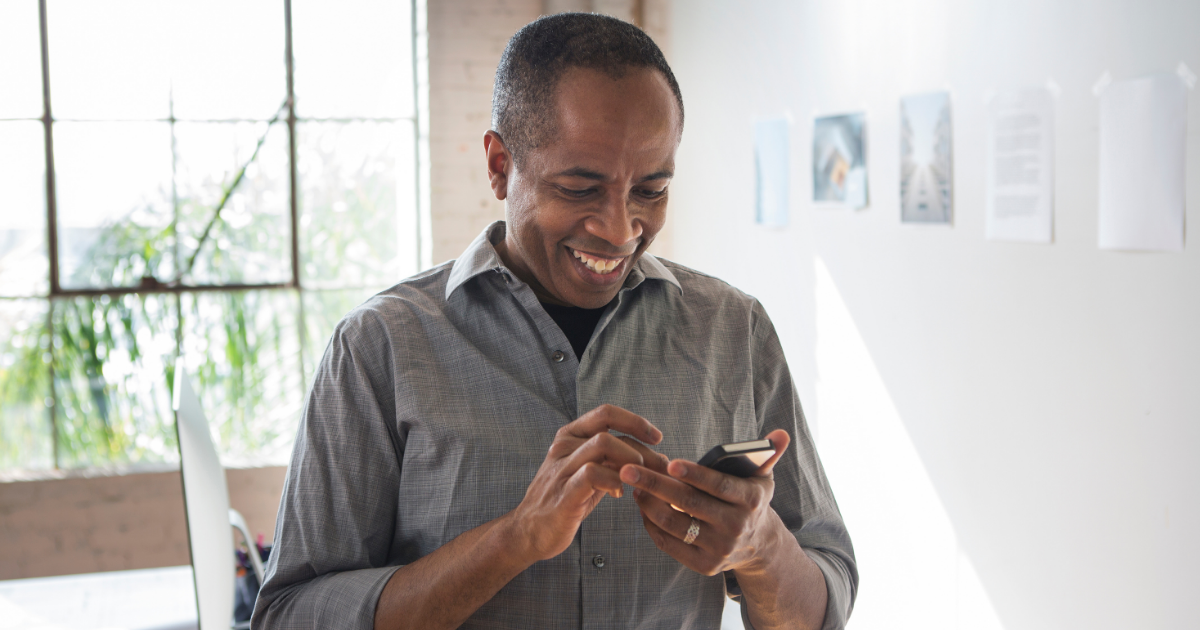 man smiling at phone